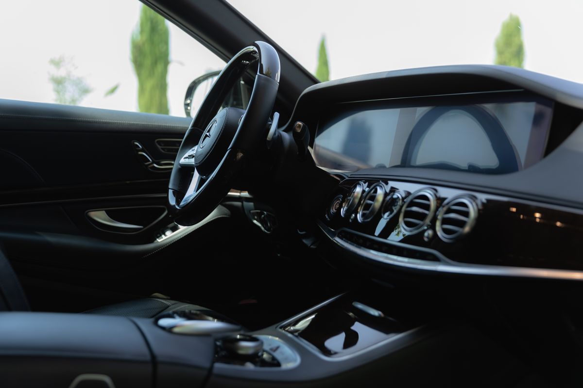 Luxury car interior with spotless dashboard and steering wheel